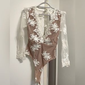 Super cute bodysuit! Never worn but tags removed. XS